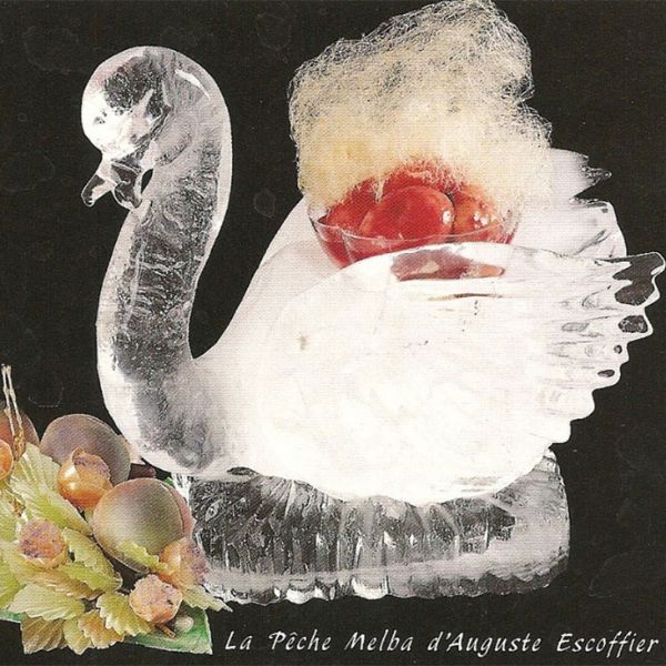 a ice sculpture of a swan with fruit in a bowl