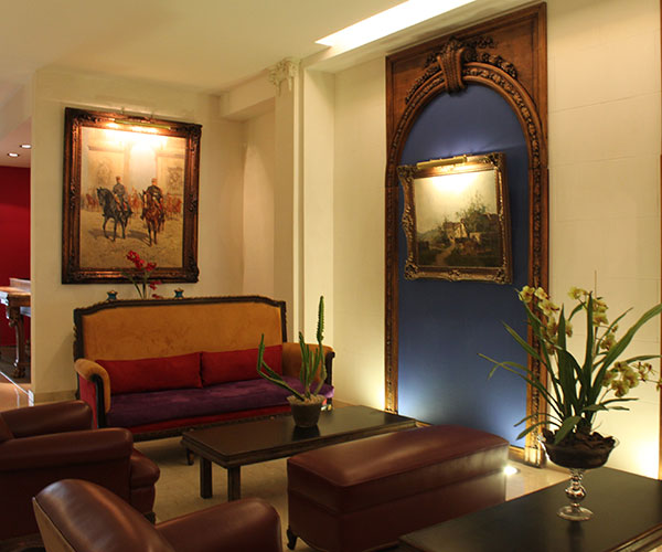 a room with couches and pictures on the wall