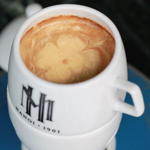 a cup of coffee with foam in it