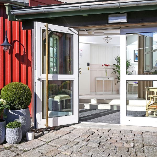 a glass doors leading to a red building
