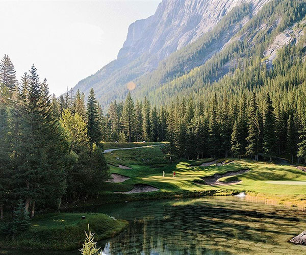 a lake surrounded by trees and mountains