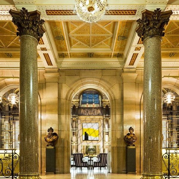 a large stone building with columns and a chandelier
