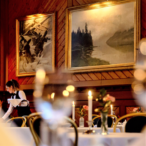a group of people sitting at tables in a restaurant