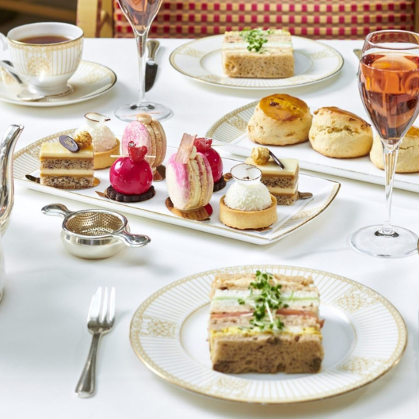 a table with plates of desserts and drinks