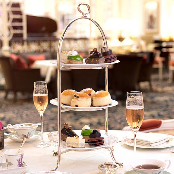 a three tiered tea set with food on it