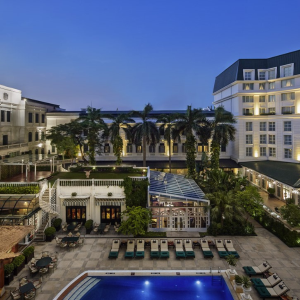 a pool in front of a hotel