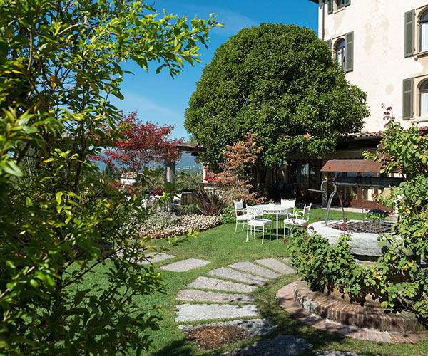 a patio with a fountain and chairs