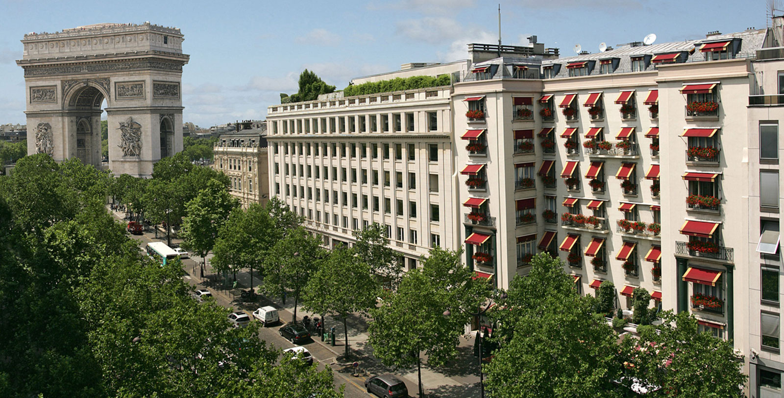 a building with trees and cars