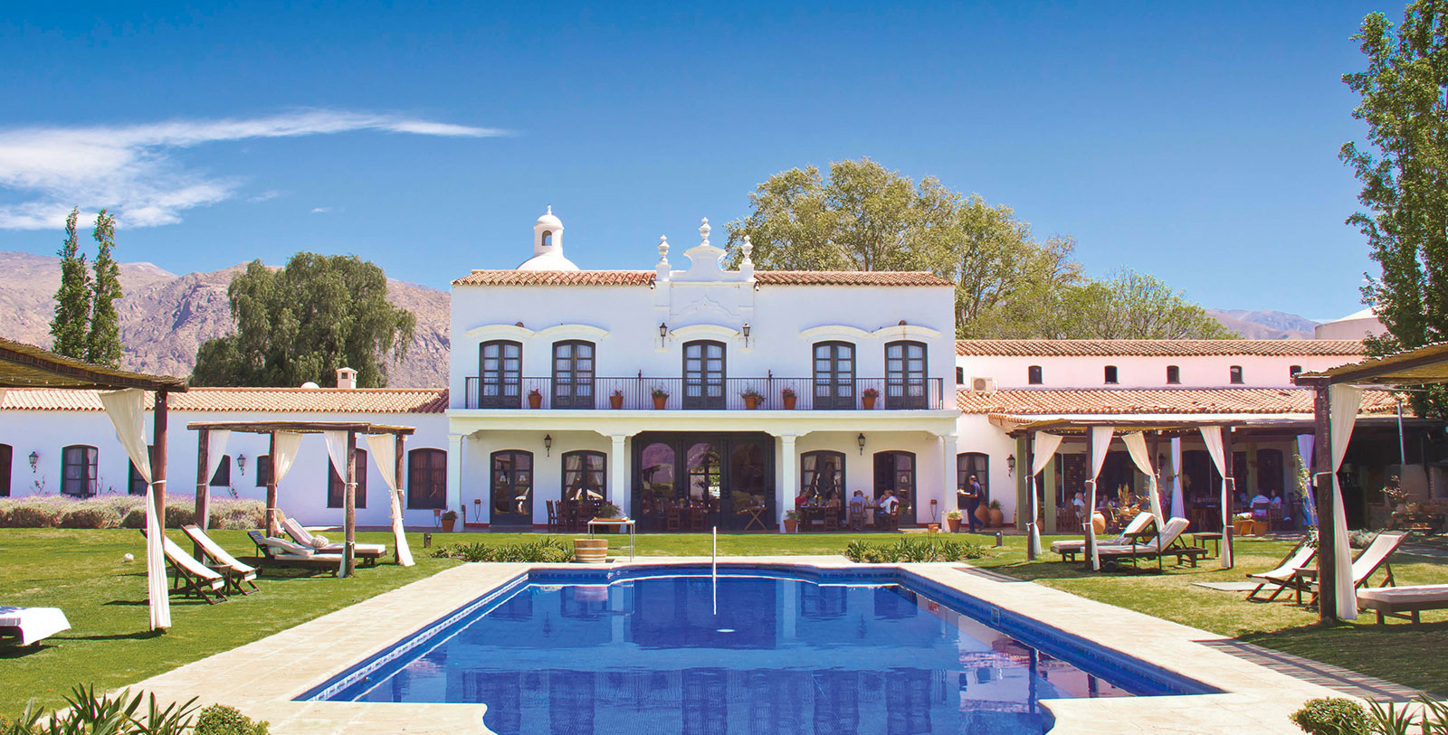 a pool in front of a white building 20