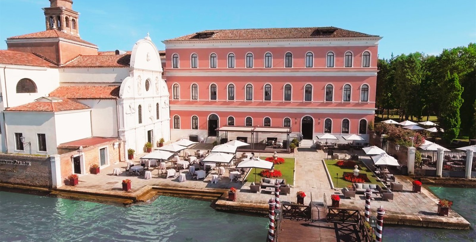 a building with tables and chairs near water