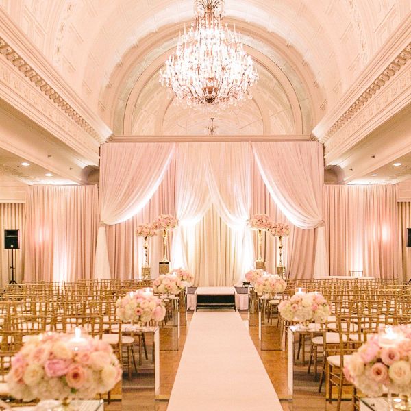 a wedding venue with chairs and flowers
