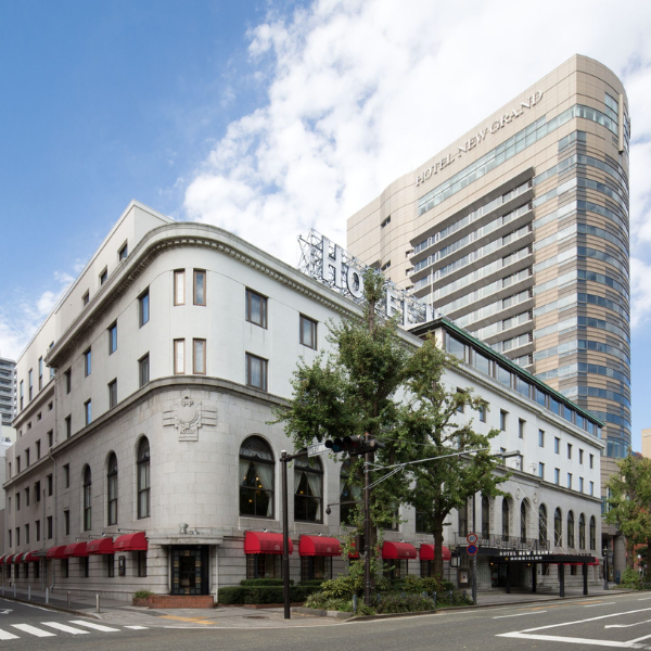 a building with red awnings and a large building with a street corner