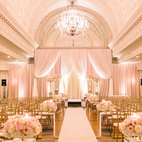a wedding ceremony with pink and white flowers