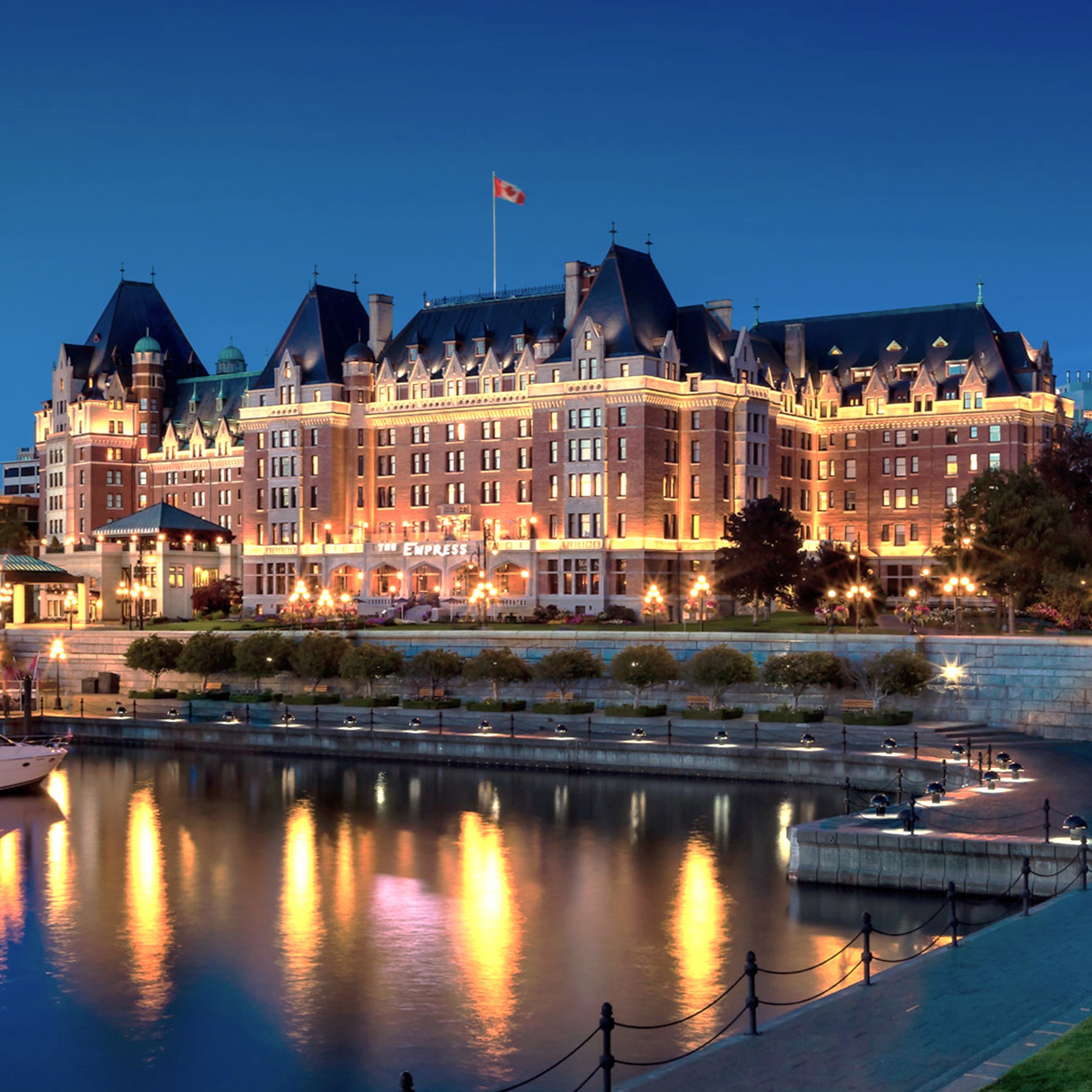 a large building with lights on it with The Empress in the background