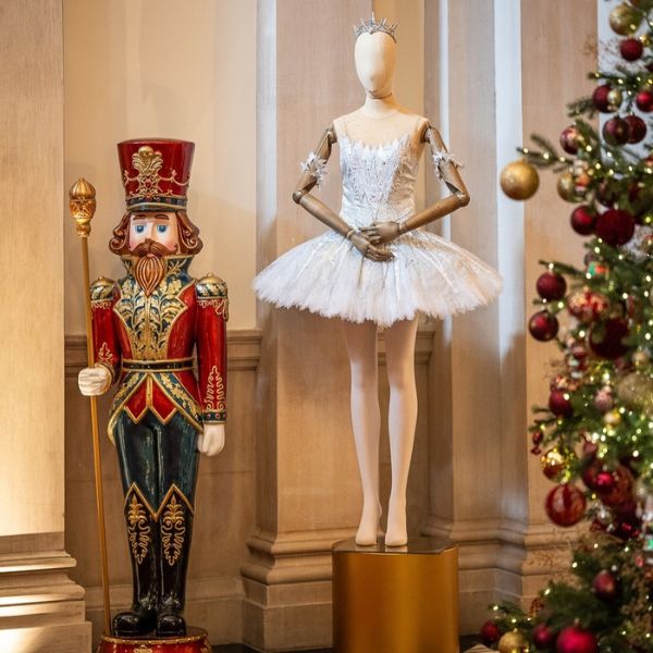 a mannequin in a tutu next to a nutcracker