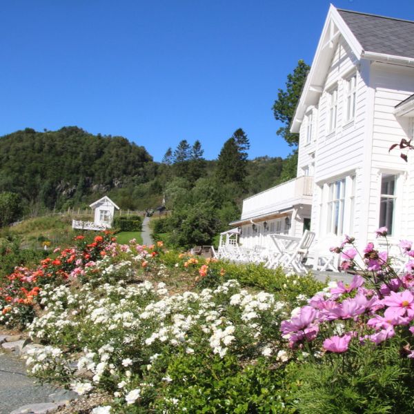 a white house with flowers in front of it