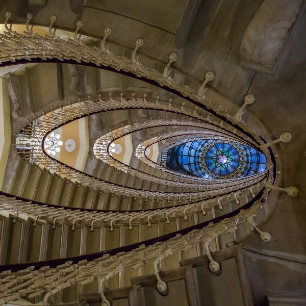 a spiral staircase with a stained glass window