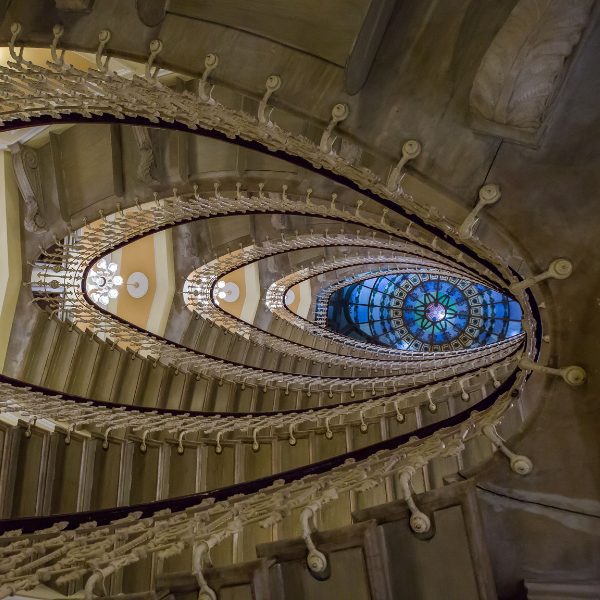 a spiral staircase with a stained glass window