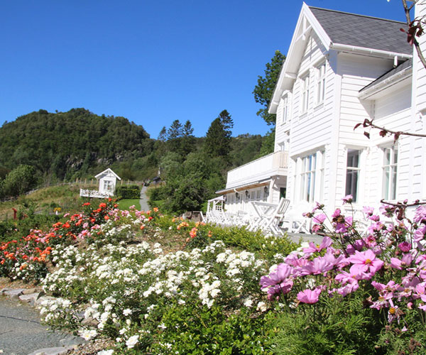 a white house with flowers in front of it