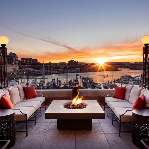 a fire pit on a rooftop with a city in the background