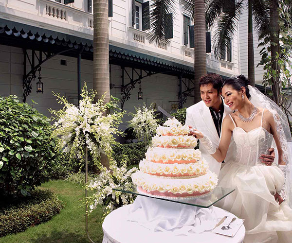 a man and woman cutting a cake