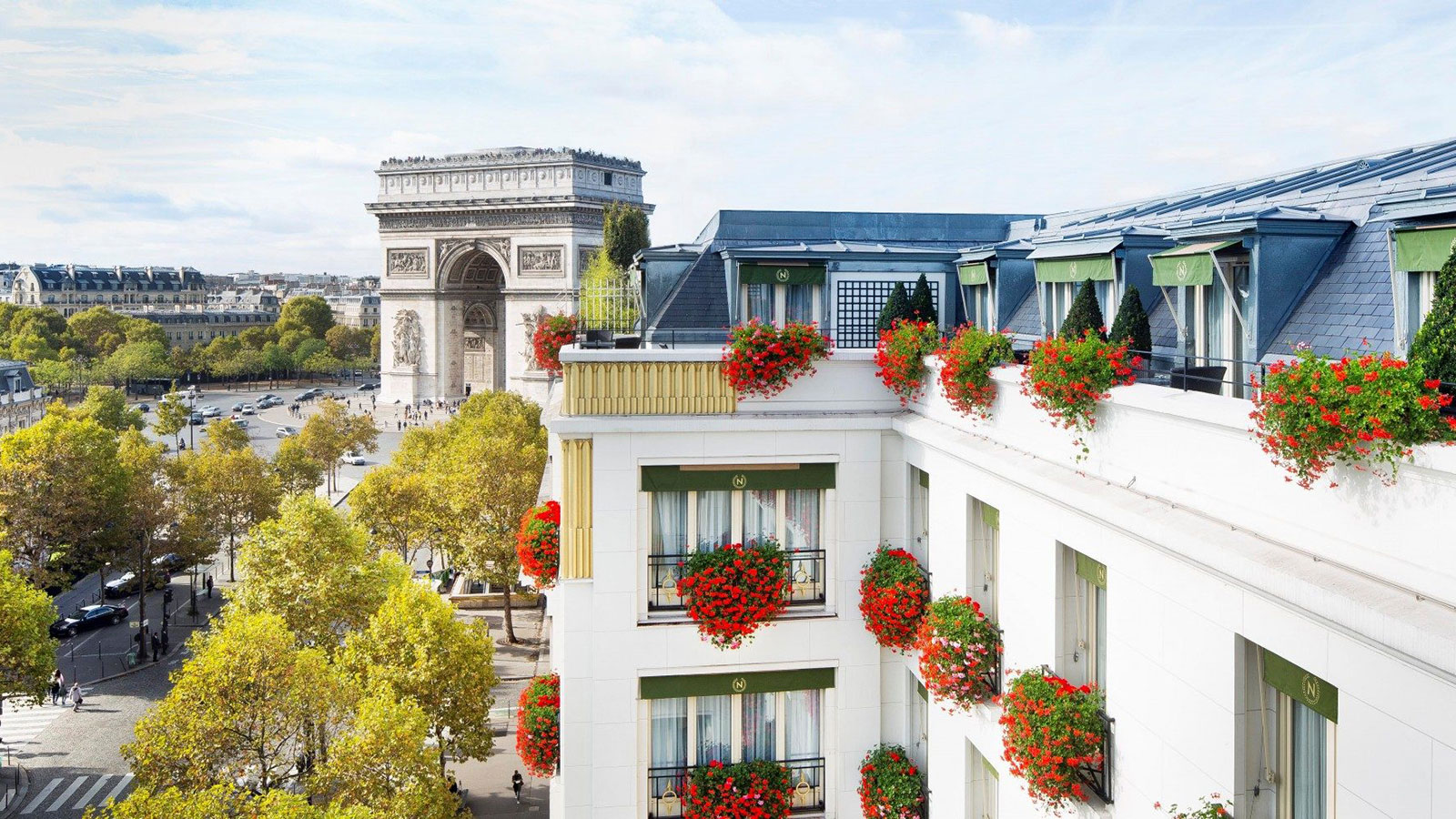 a building with flowers on the balcony