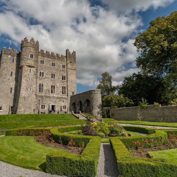 a castle with a garden and a path