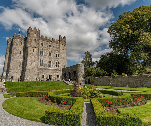 a castle with a garden and a path