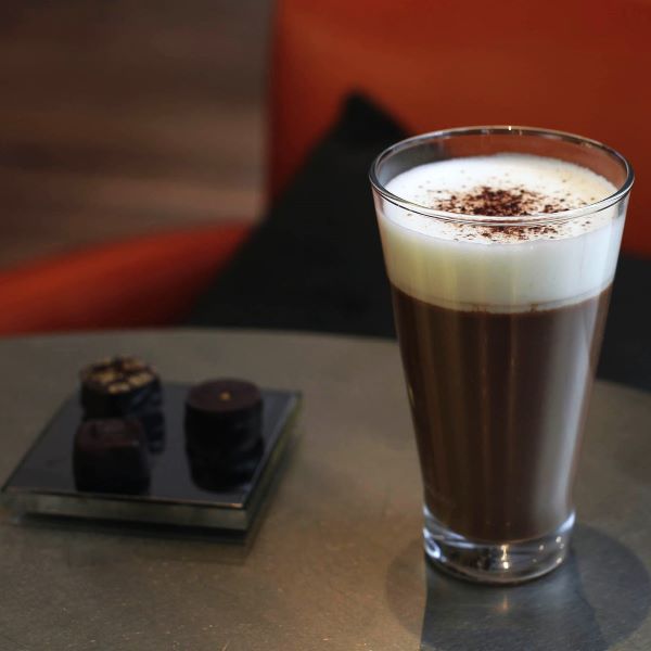 a glass of chocolate drink on a table