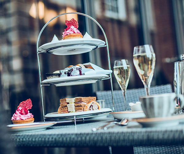 a three tiered tray with food on it