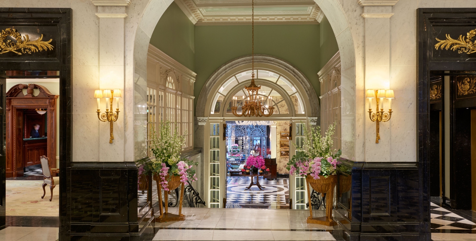 a hallway with flowers in pots