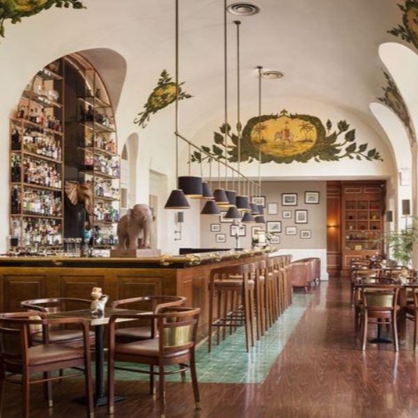 a bar with chairs and tables in a room