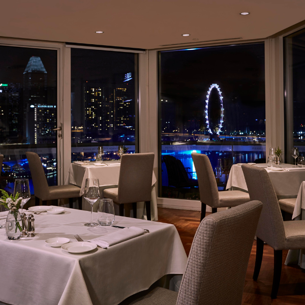 a restaurant with tables and chairs and a ferris wheel