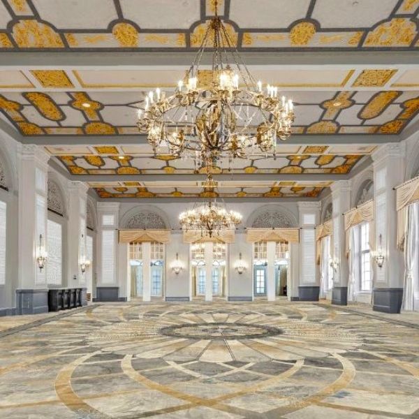 a large room with chandeliers and a patterned floor