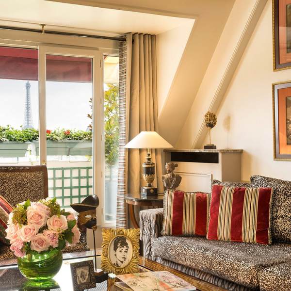 a living room with a couch and a vase of flowers
