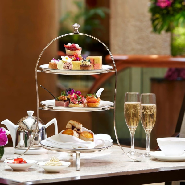 a three tiered tray with food on it