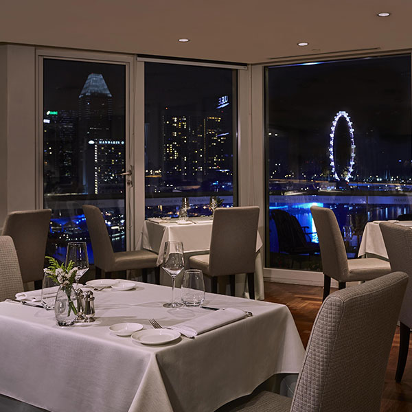a restaurant with a view of the city from the window