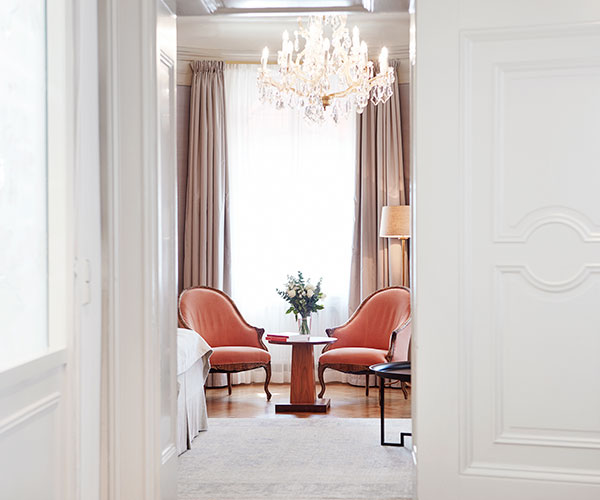 a room with a chandelier and chairs