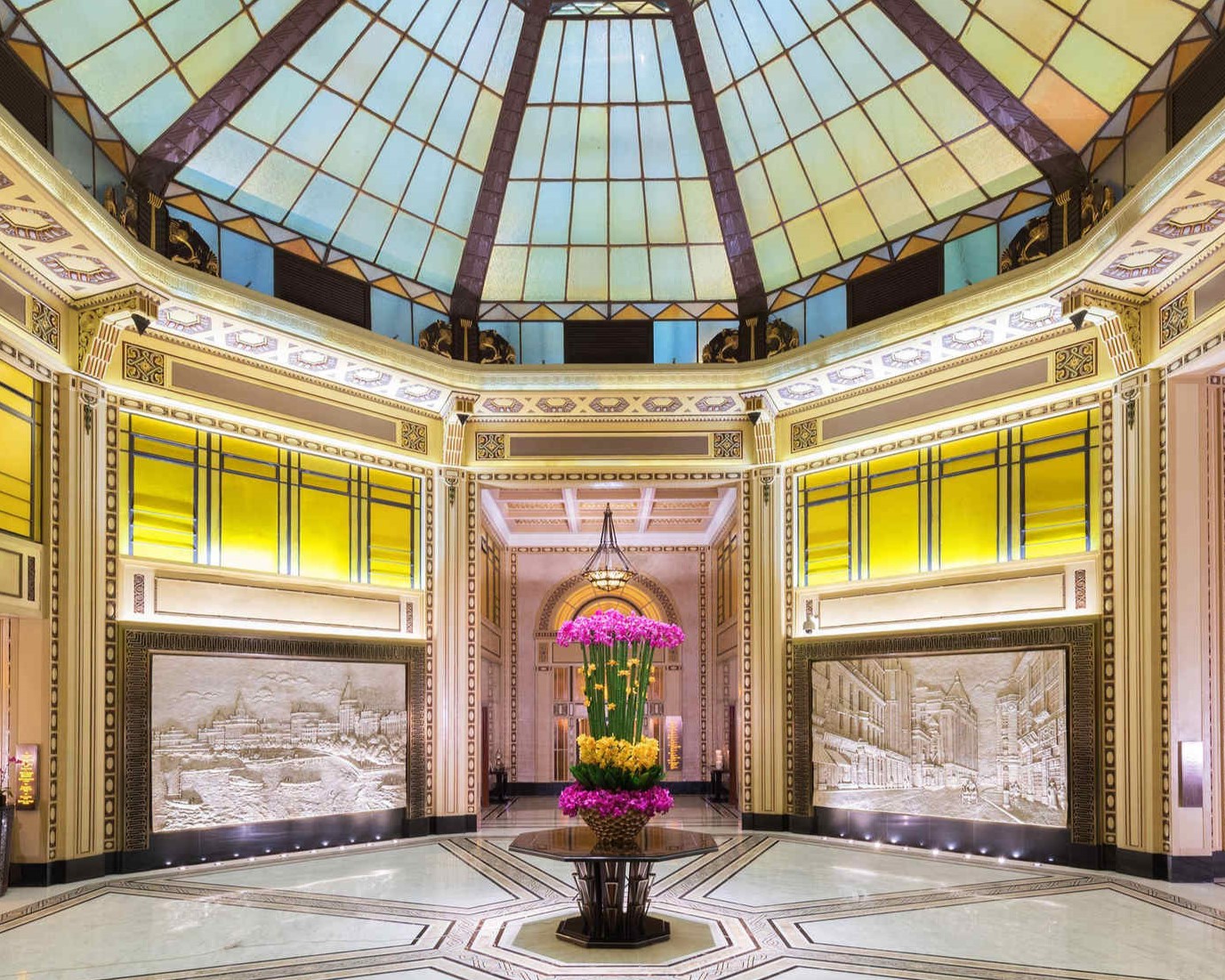 a large glass dome with a vase of flowers