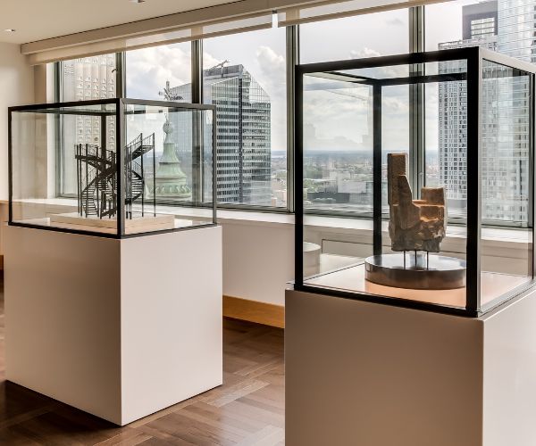 a room with glass cases and a statue in it
