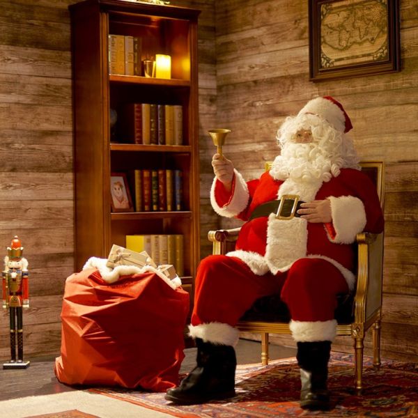 a man in a santa garment holding a bell