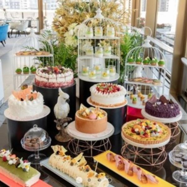 a table with different cakes and desserts