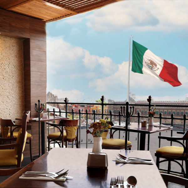 a table with chairs and a flag in the background