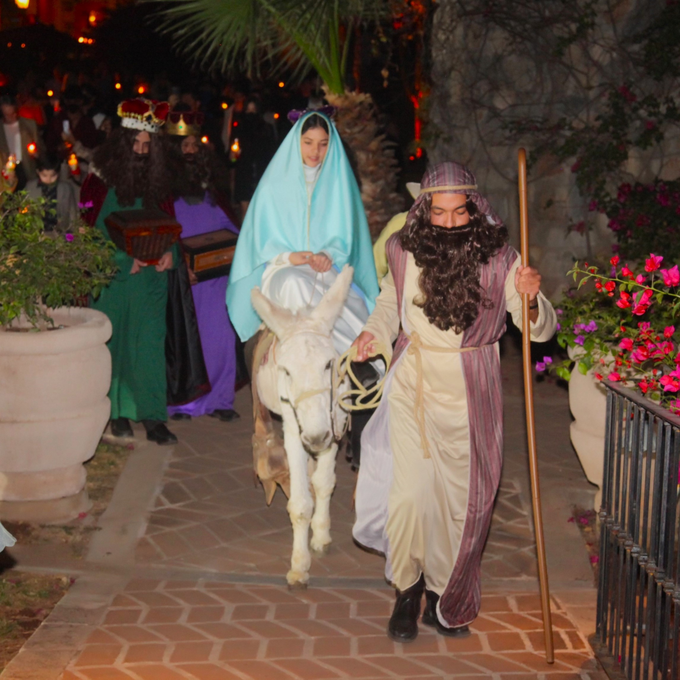 a man and woman in garment walking on a donkey