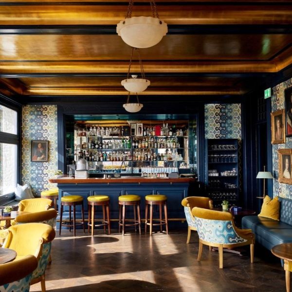 a room with a bar and chairs