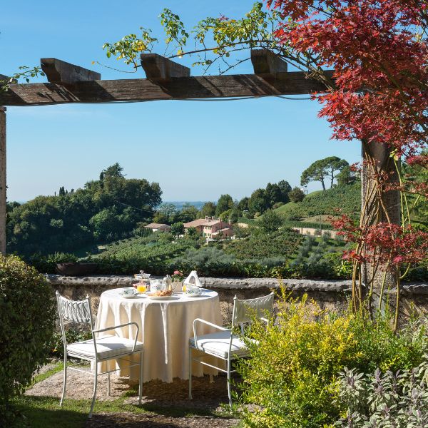 a table and chairs under a pergola