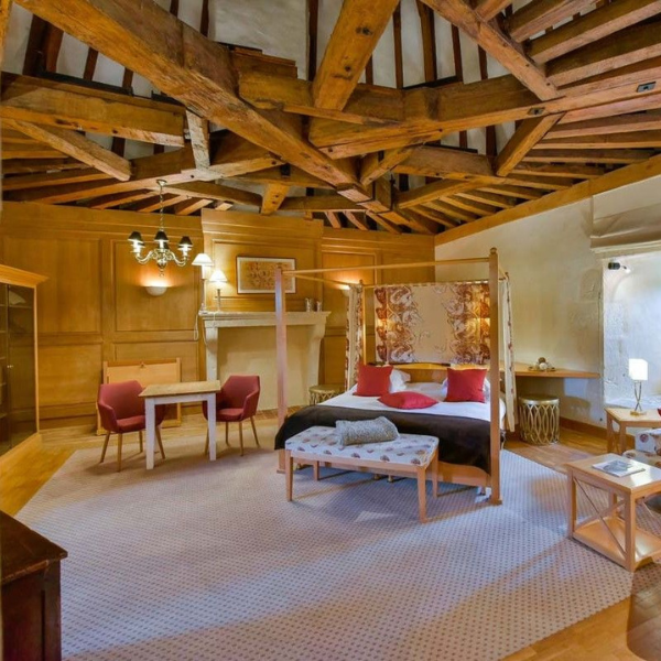 a bedroom with a bed and a fireplace