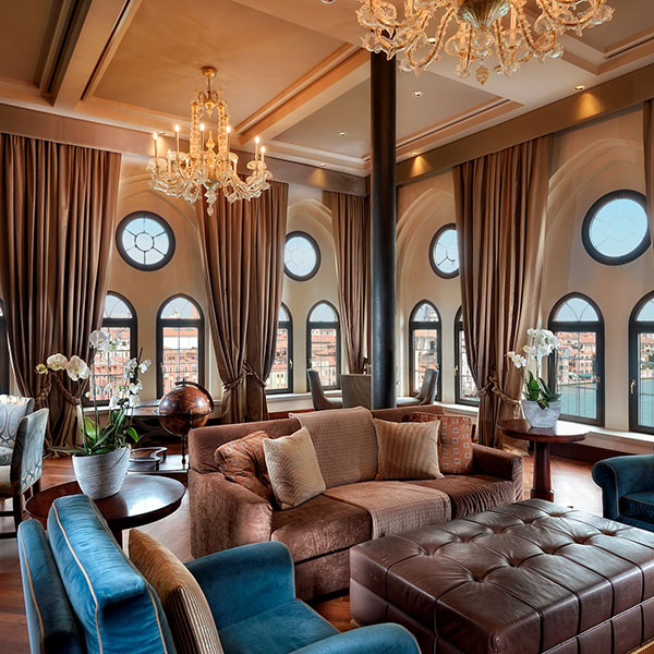 a room with a chandelier and couches