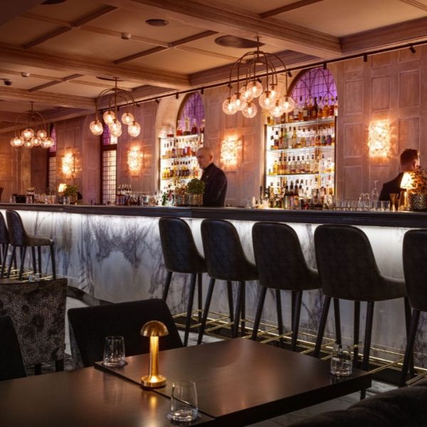 a bar with a counter and chairs