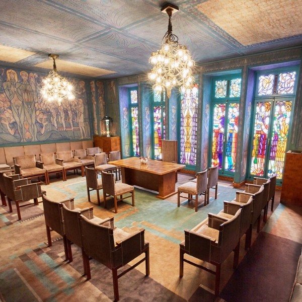 a room with many chairs and a table